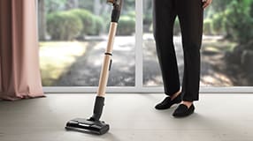 Man vacuuming carpet