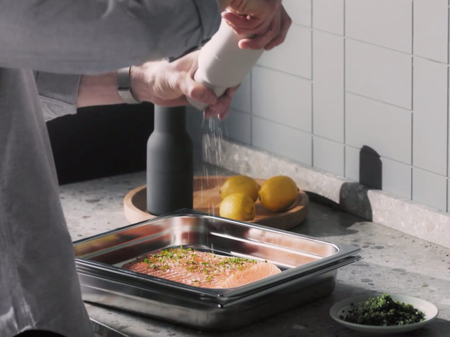 preparing salmon with salt and herbs